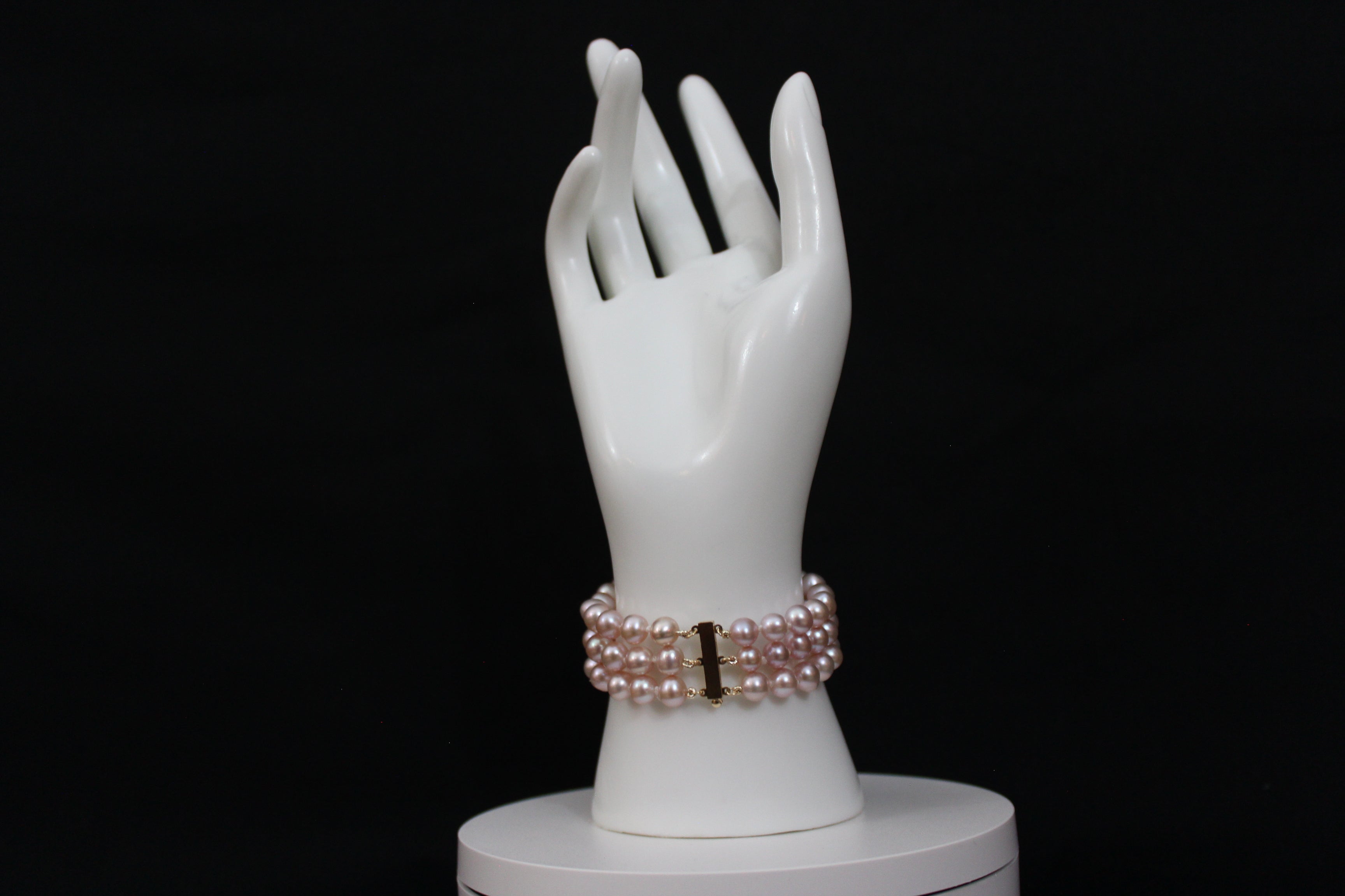 Pink rose cultured semi-round pearl bracelet triple strand with 14 karat gold lock.  (Free shipping and taxes).