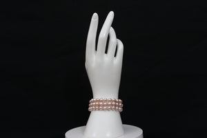 Pink rose cultured semi-round pearl bracelet triple strand with 14 karat gold lock.  (Free shipping and taxes).