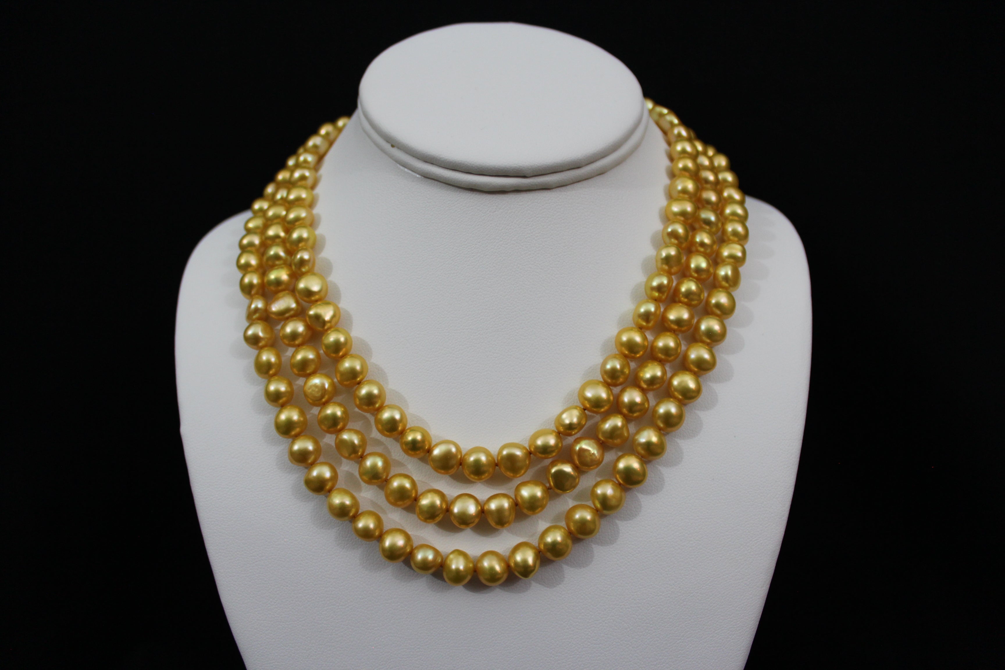 Gold color cultured button pearl necklace triple strand with 14 karat gold lock.  (Free shipping and taxes).