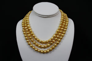 Gold color cultured button pearl necklace triple strand with 14 karat gold lock.  (Free shipping and taxes).