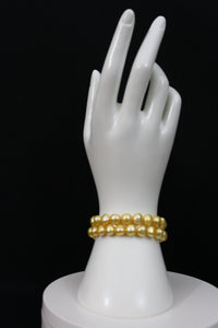 Gold color cultured button pearl shape bracelet 2 strands with 14 karat gold clasp.  (Free shipping and taxes).