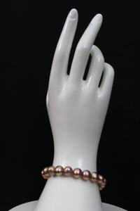 Rose gold cultured circled baroque pearl bracelet single strand with 14 karat clasp.  (shipping and taxes free).