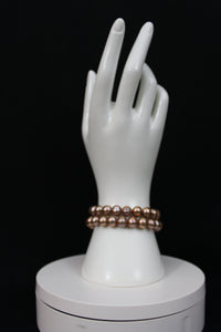 Rose gold cultured circled baroque pearl bracelet double strand with 14 karat clasp.  (shipping and taxes free).