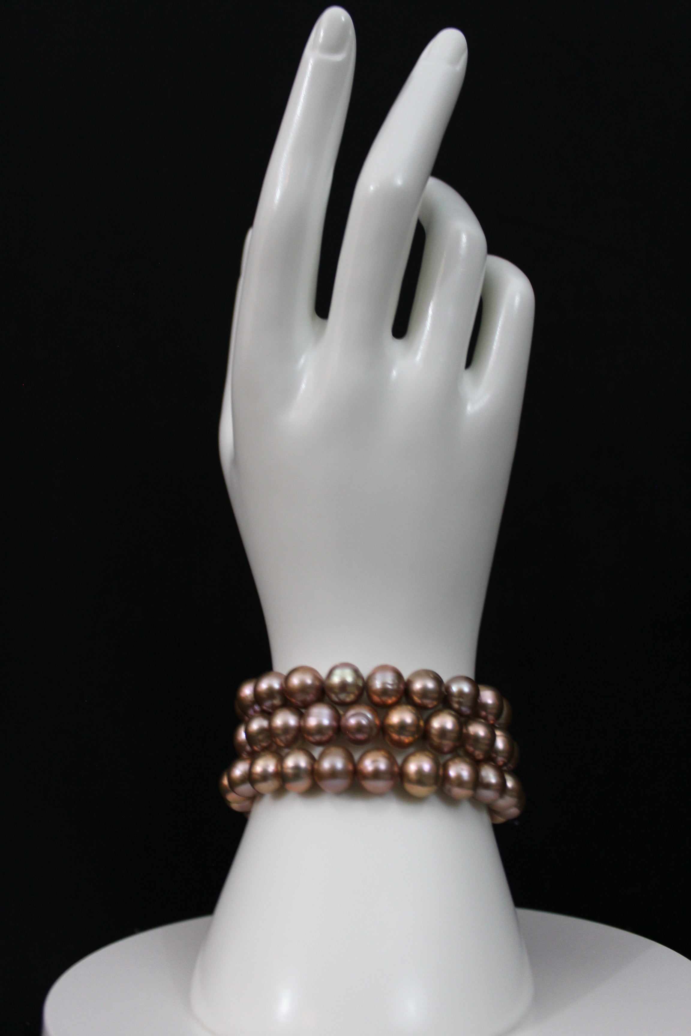 Rose gold cultured circled baroque pearl bracelet triple strand with 14 karat clasp.  (shipping and taxes free).