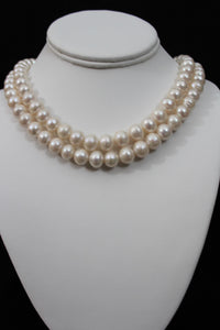 White color cultured  circled baroque pearl double string necklace with 14 karat gold closure.  (Free shipping and taxes).