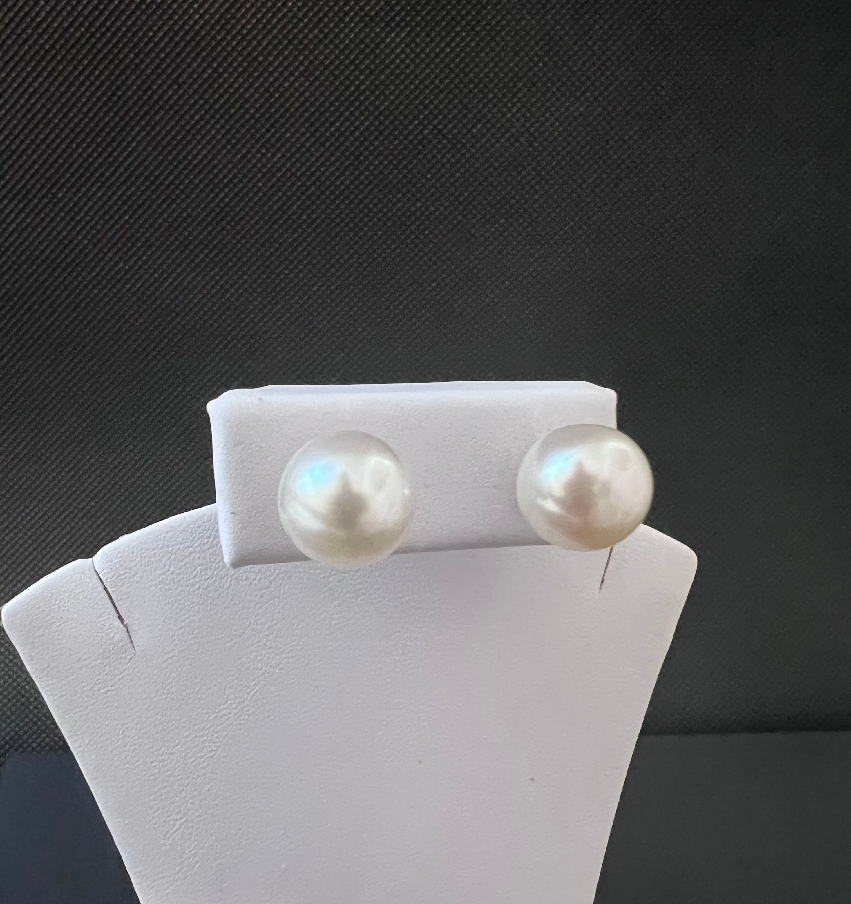 White color cultured circled baroque pearl earring set with 14 karat studs.      (Free shipping and taxes).