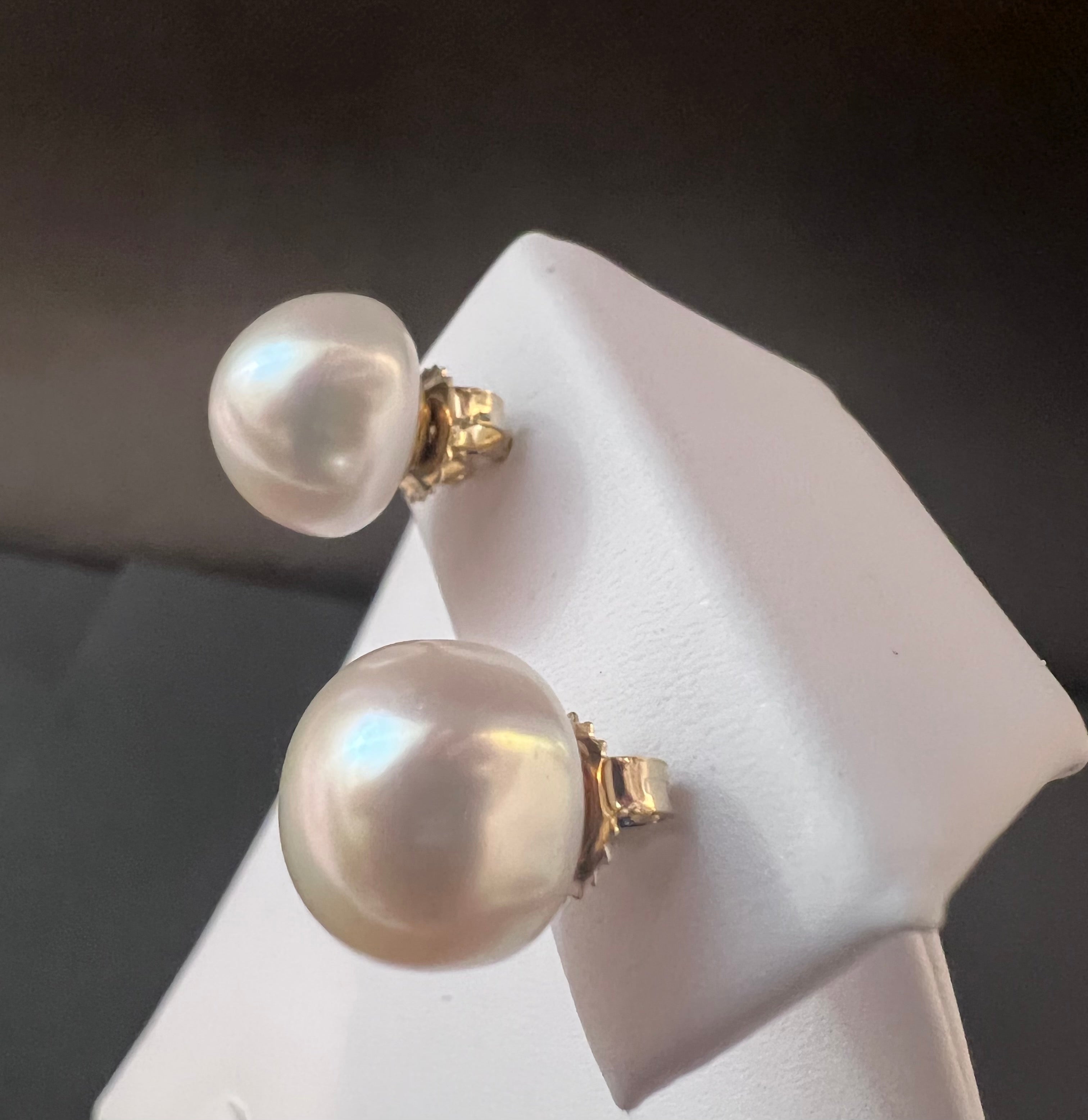 White color cultured circled baroque pearl earring set with 14 karat studs.      (Free shipping and taxes).