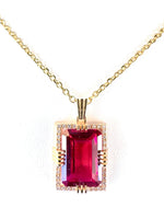 Load image into Gallery viewer, Ruby created center stone 18 Karat gold Pendant with gold chain and garnished with 32 round clear synthetic diamonds.     (Free shipping and taxes).
